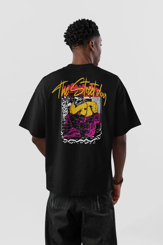Model wearing black Street Dog graphic oversized t-shirt with colorful back print streetwear artwork by Cluvian