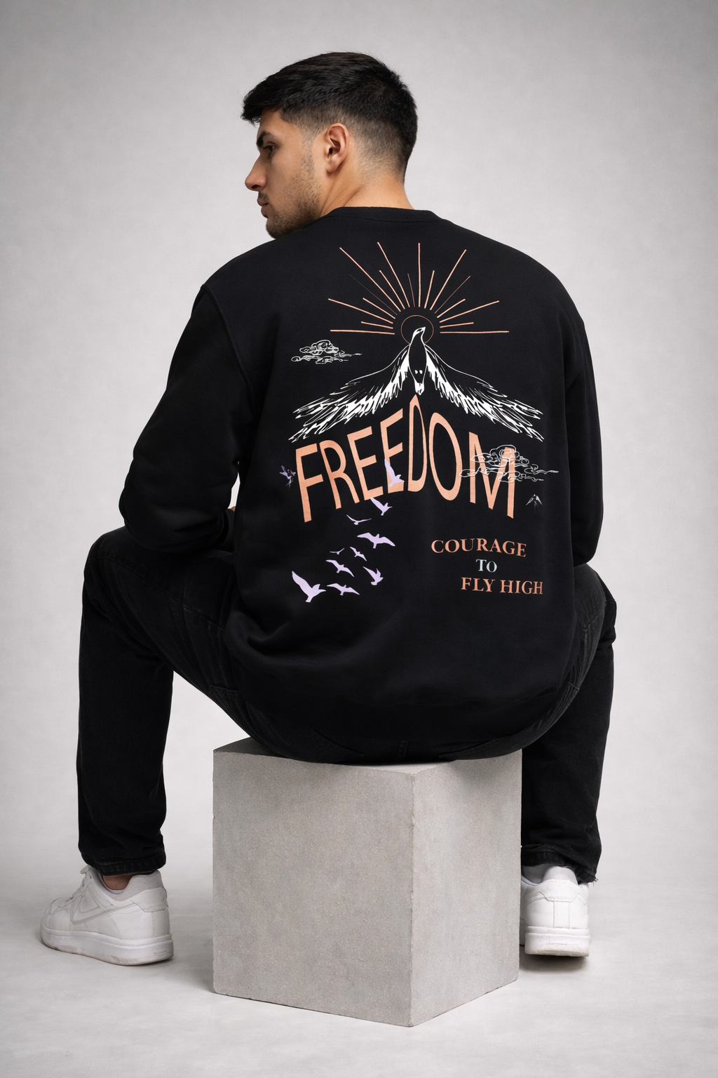Men wearing black Freedom graphic streetwear sweatshirt with oversized back print design by Cluvian